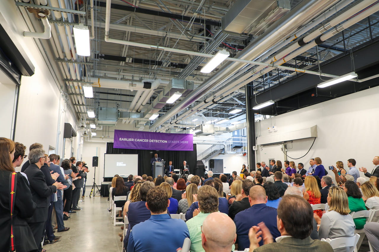 Neighbors, community leaders and local officials fill the seating area just outside the doors to the laboratory.